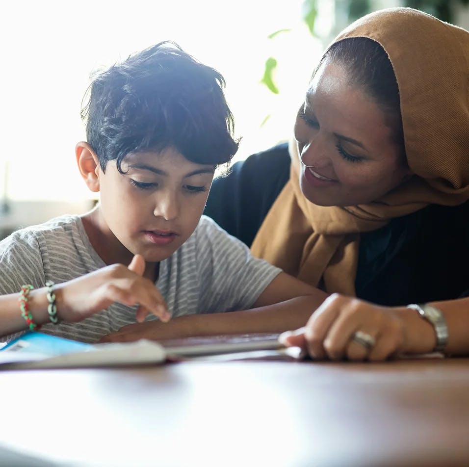 image of woman helping a child with homework